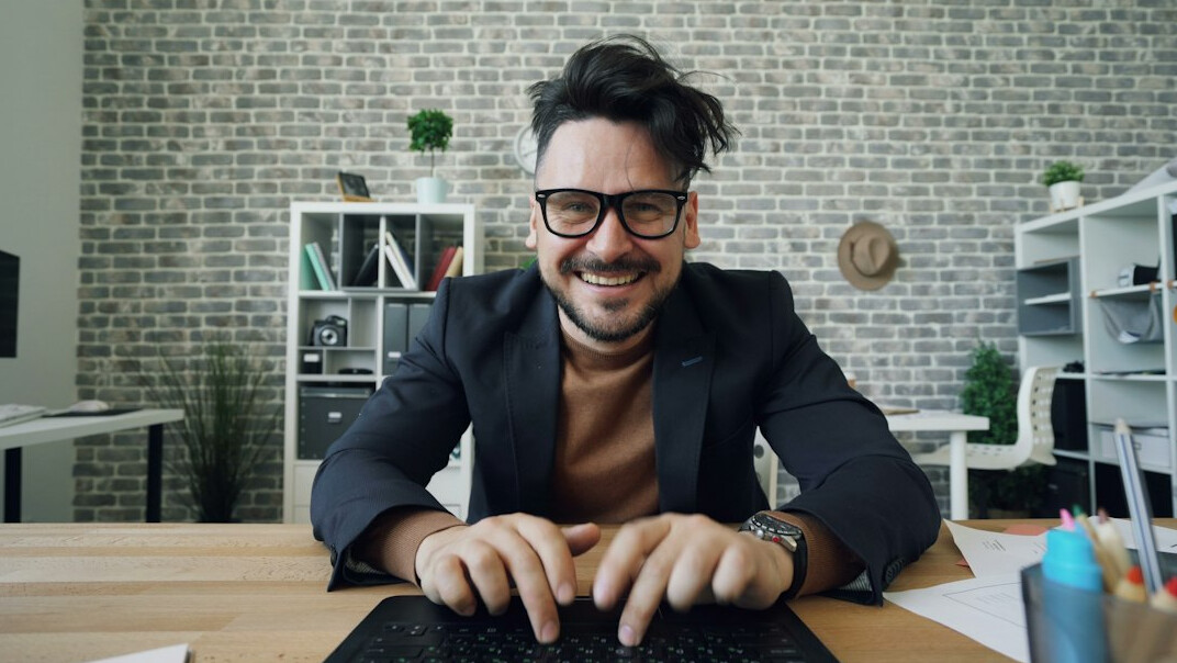 happy professional at desk